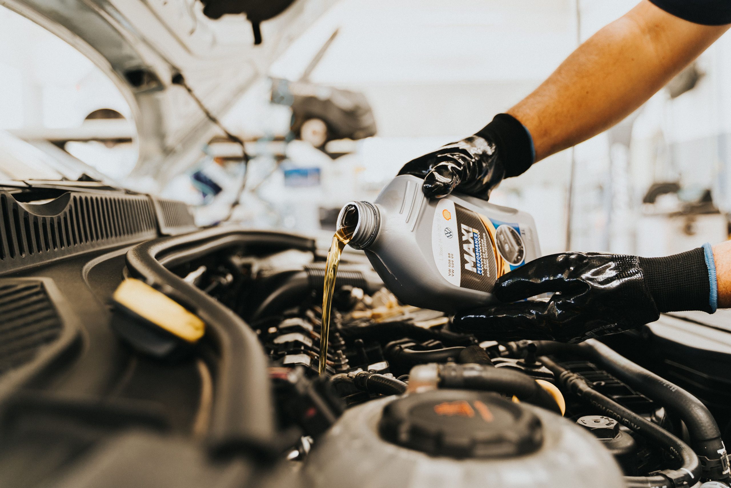 A car repair technician in Bossier City changing oil on a truck