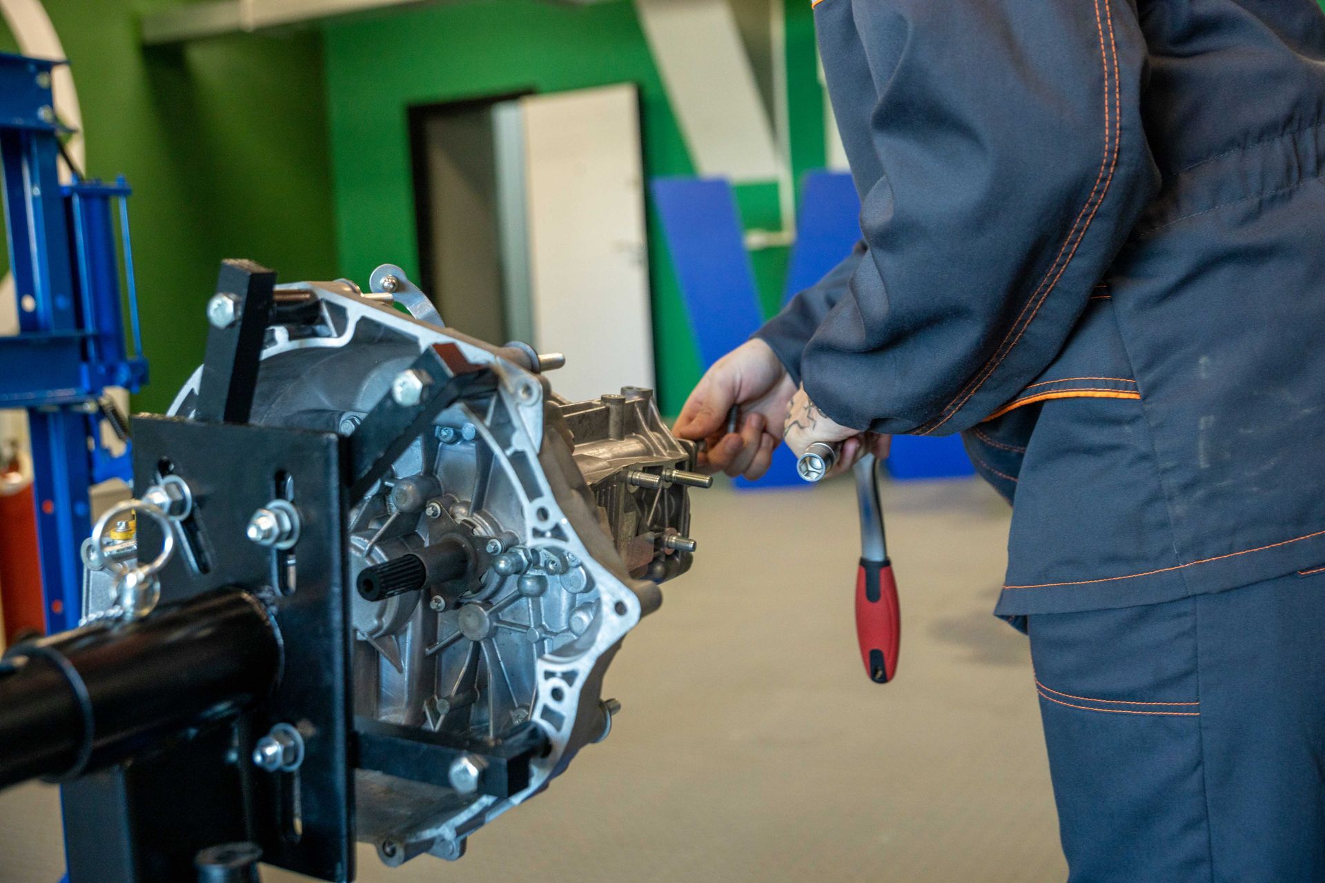 A car repair technician working on a transmission in a shop in Bossier City