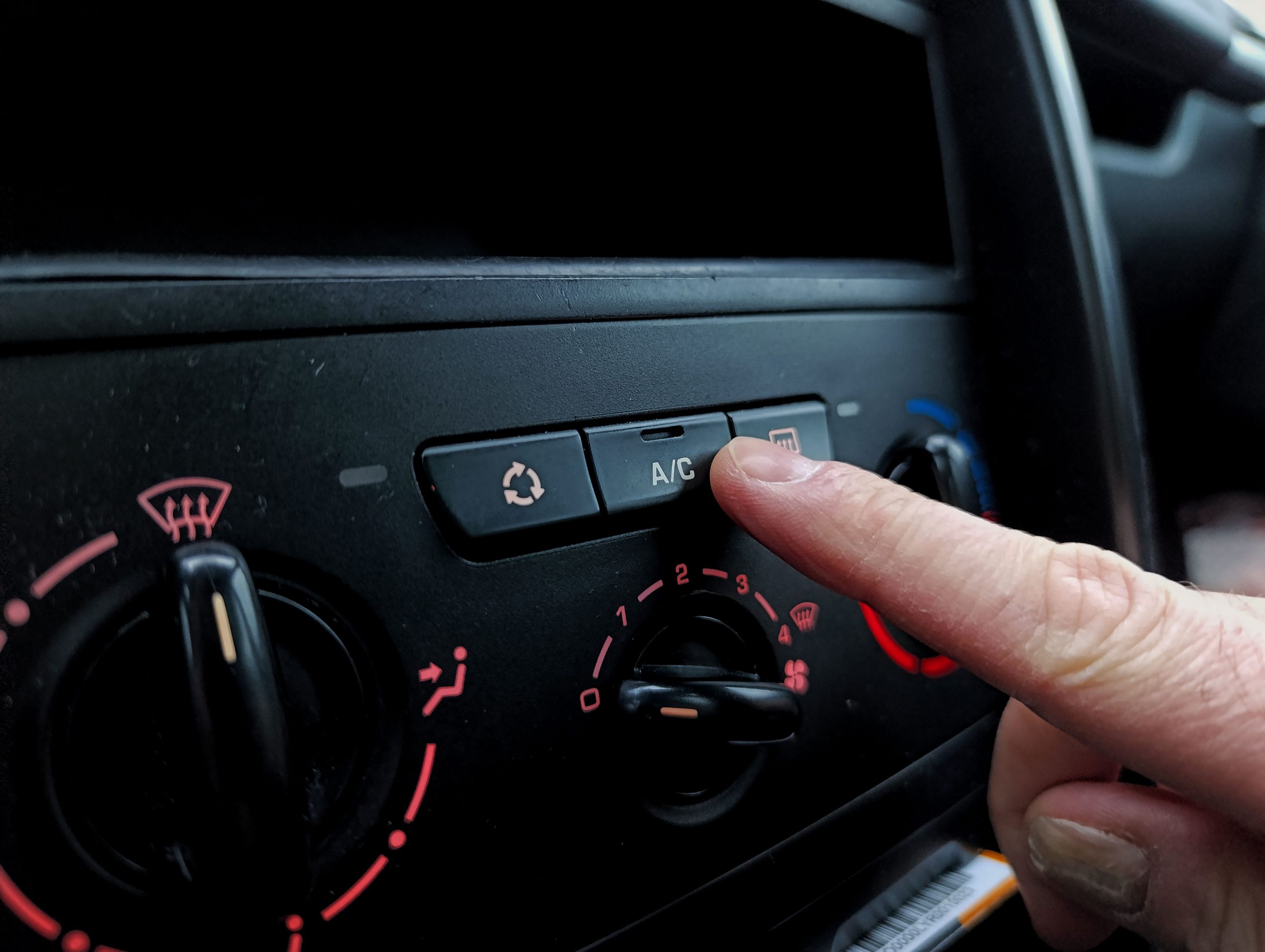 A car repair technician in Bossier City checking the AC