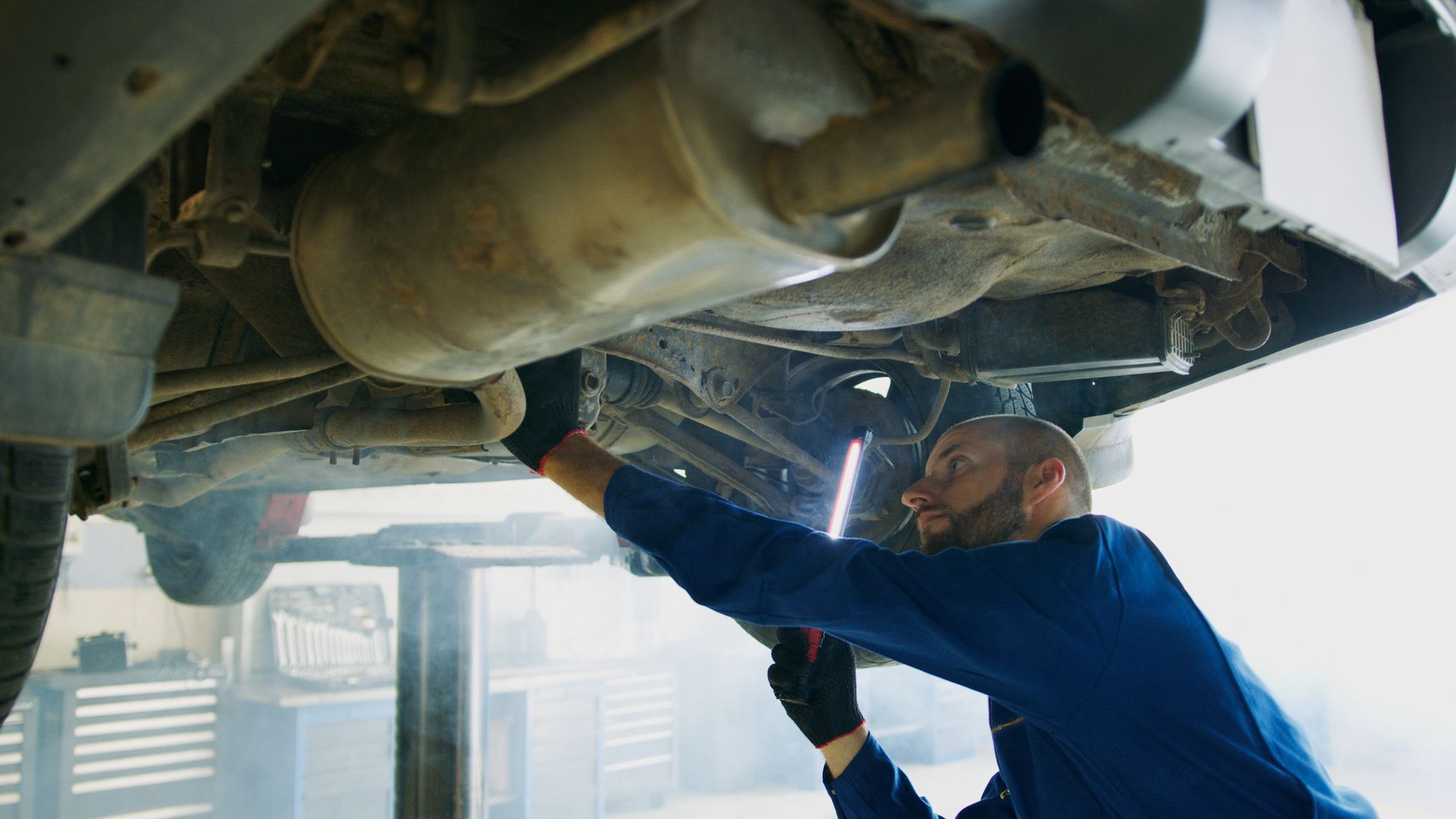 A car repair technician checking for leaks in a shop in Bossier City