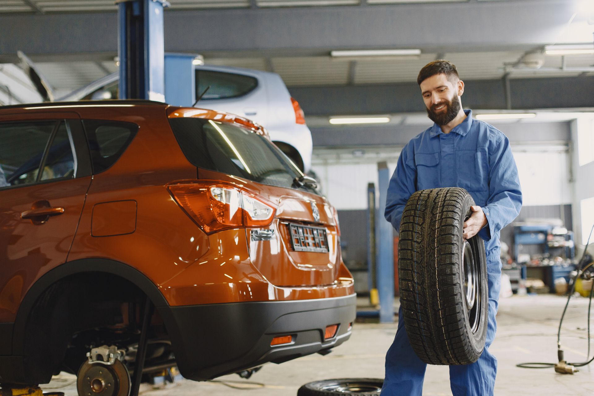 A car repair technician changing a tire in Bossier City