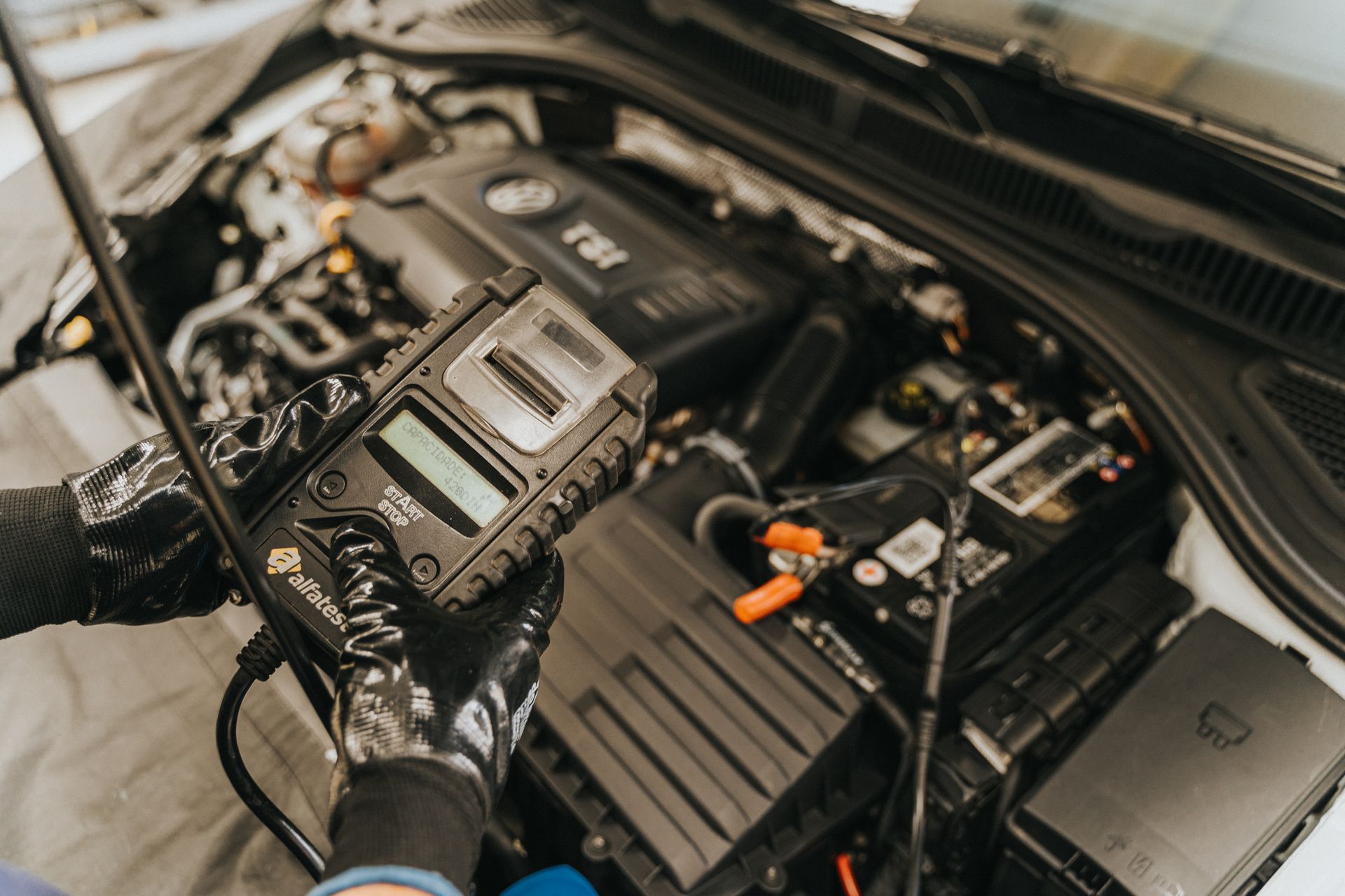 A car repair shop technician in Bossier City checking the engine